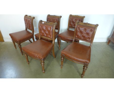 A set of five Victorian oak library chairs, with leatherette button backs and overstuffed seats, two stamped to back legs 190