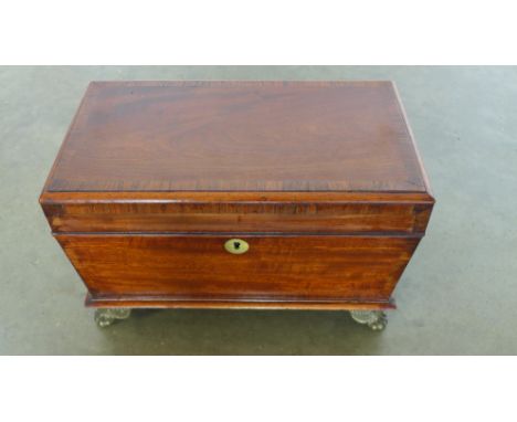 A Georgian mahogany and crossbanded sarcophagus shaped tea caddy with twin brass side handles and carved feet - 20cm x 33cm x