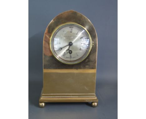 A polished brass lancet shaped mantle clock with American movement retailed by The Goldsmiths and Silversmiths Company London