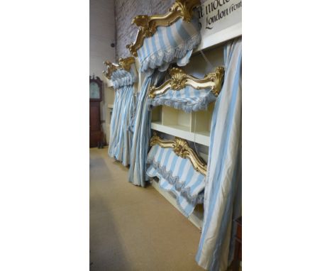 Six lined light blue and white striped silk curtains - with four rococo style giltwood pelmets tasselled tie backs and gilt w