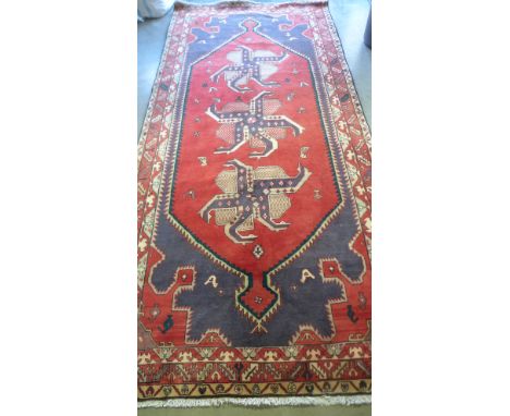 A woollen Caucaian carpet - 305cm x 146cm 