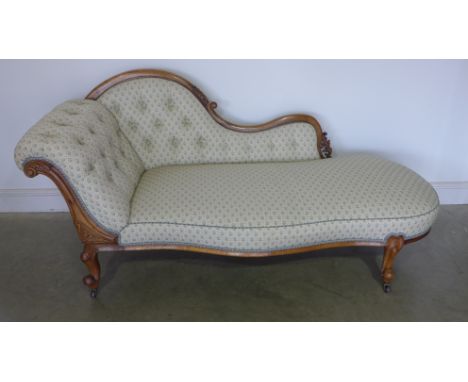 A 19th century walnut framed chaise longue with carved back and support, button back fabric upholstered on cabriole legs and 