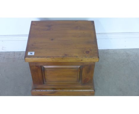 A smaller pine trunk with lift up lid, panelled front on plinth - 35cm x 37cm x 30xm 