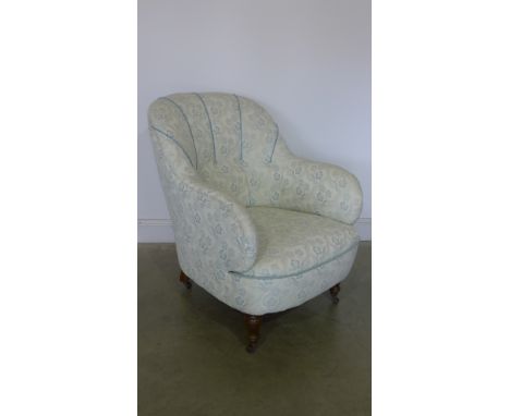 A Ladies Victorian mahogany framed easy chair with button backed fabric upholstery, rounded supports on turned legs and casto