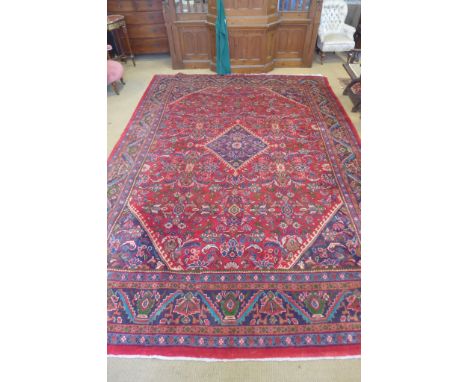 A red ground handmade Persian Sarouk carpet - 4.15m x 2.90m