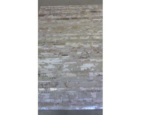 A beige ground leather cowhide carpet - 2.30m x 1.60m