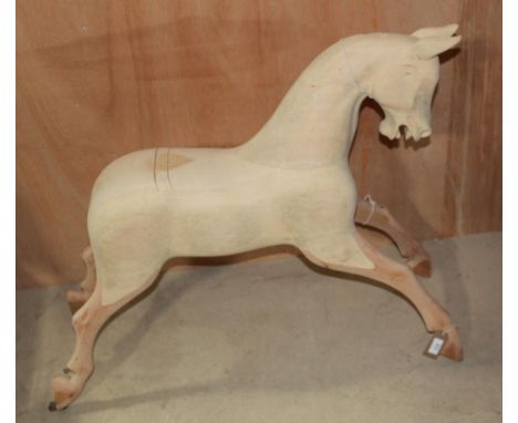 Medium size hand carved modern rocking horse. Unpainted, lacking eyes, swing rocker, tack, mane and tail. Height to crest 76c