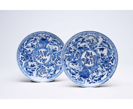 A pair of Chinese blue and white plates with floral design and animated landscapes, KangxiDia.: 26 cm