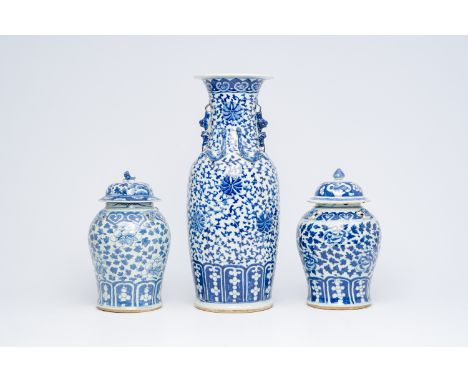 A Chinese blue and white 'lotus scroll' vase and a pair of 'peony scroll' vases, 19th C.H 61,3 cm (the tall vase)  H 36 - 37 