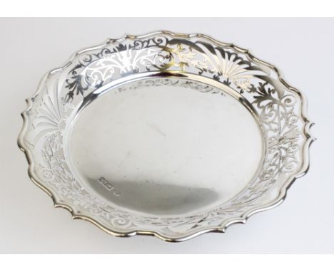 An Edwardian silver bonbon dish by Sibray, Hall & Co Ltd, London 1909, with pierced decoration to pie crust border on three s