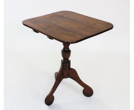 A George III oak tripod table, the rectangular top with rounded corners, raised upon a ring turned baluster pedestal extendin