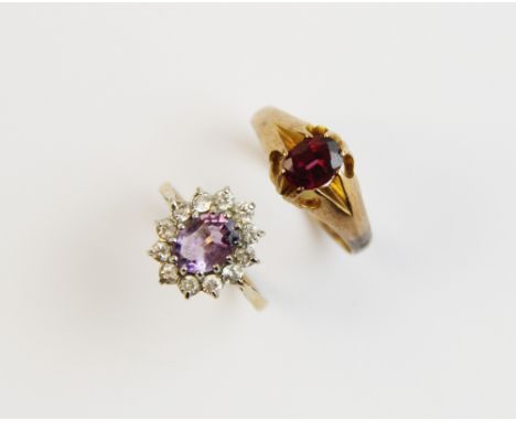 A Victorian garnet set 9ct gold ring, Birmingham 1890 comprising a central oval cut garnet measuring 7mm x 5mm, claw set to a