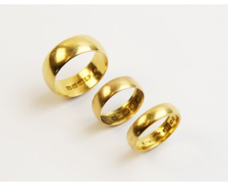 Three 22ct plain polished gold wedding bands, one ring size S, one ring size K, one ring size K ½, gross weight of group 19.6
