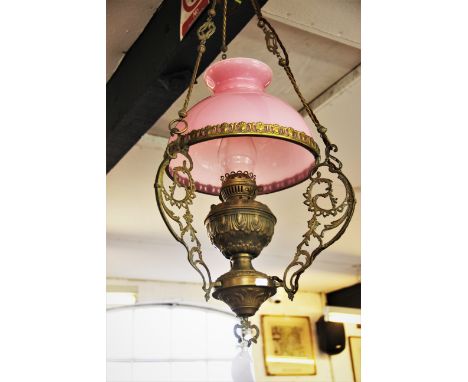 A French ceiling hanging oil lamp, late 19th century, the brass lamp body with scrolling pressed relief Art Nouveau motifs, s