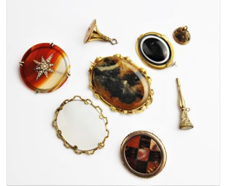 A Victorian Scottish agate plaid brooch, comprising alternating squares of coloured agates, set to a plain polished border wi
