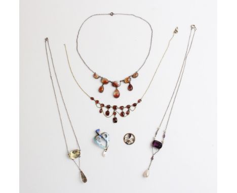 A selection of vintage necklaces and pendants, to include an Arts and Crafts style pendant in the form of a heart decorated w