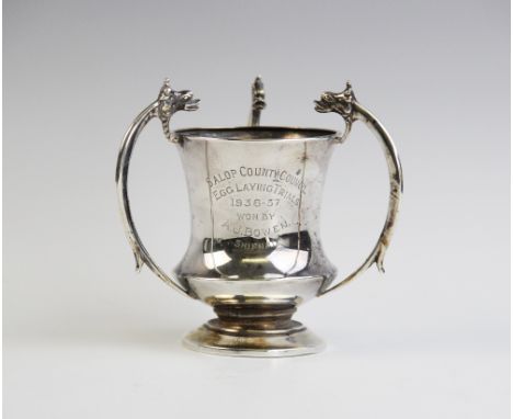 A silver and silver gilt Arts & Crafts style trophy cup by Robinson & Co, Birmingham 1935, of tapering form on pedestal foot 