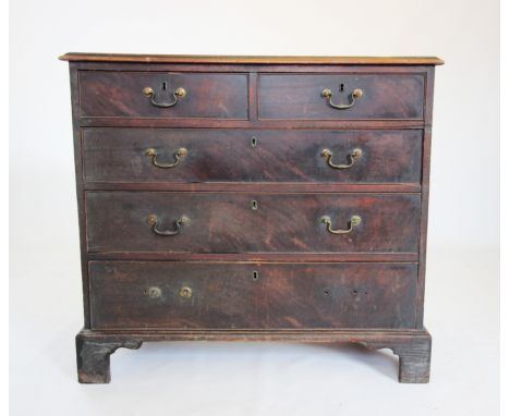 A George III mahogany chest of drawers, the rectangular moulded top above two short and three long cock beaded drawers, appli