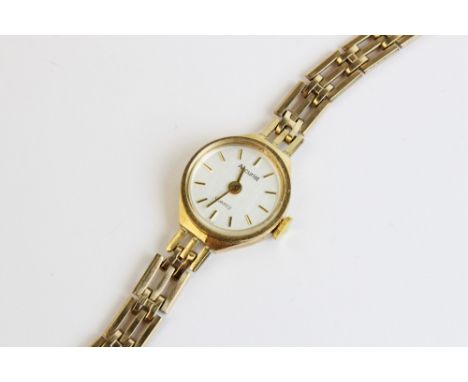 A lady's vintage 9ct gold Accurist Quartz wristwatch, the circular pearlescent dial with baton markers, set to a plain polish