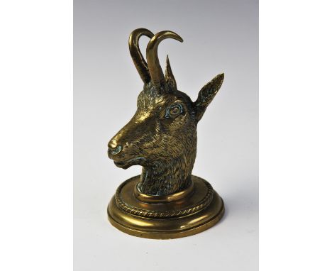 A Victorian novelty brass inkwell modelled as a goats mask, with hinged cover on a circular base, 18.5cm high For condition i