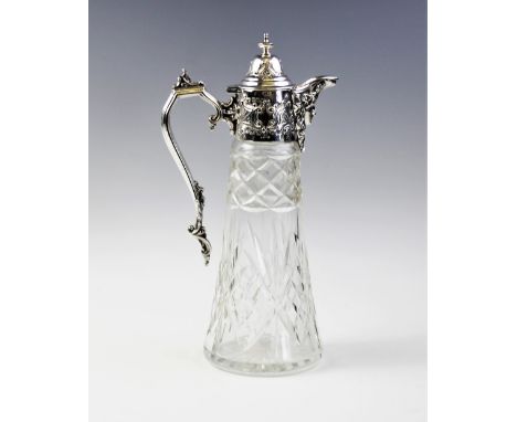 An Edwardian silver mounted cut glass claret jug, Sheffield 1905, of tapering form with star cut base, with mask of Dionysus 