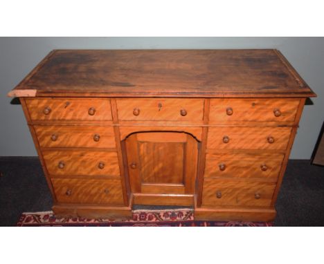 A Victorian satinwood knee hole dressing table/desk, the rectangular thumb moulded top above a central frieze drawer and rece