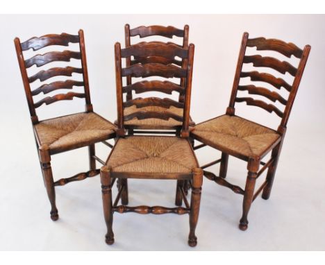 A set of 18th century style oak ladder back kitchen chairs, late 20th century, each with five graduated rungs above an envelo