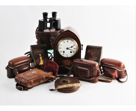 An Edwardian mahogany cased mantel clock, of lancet form, the case inlaid with a bat wing fan, enclosing a 10cm white enamel 