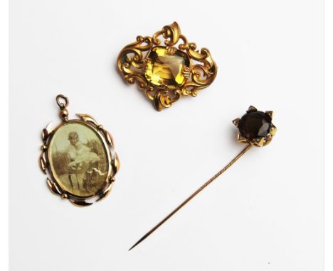 An early 20th century citrine and diamond set stick pin, comprising a central round mixed cut citrine measuring 15mm diameter