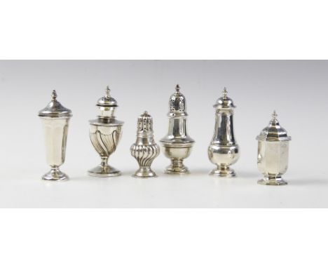 A silver pepperette by Walker &amp; Hall, Sheffield 1913, of urn form on pedestal foot with half-reeded decoration to body, p