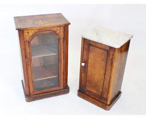 A Victorian figured walnut pot cupboard, the white marble slab top above a single panelled door applied with a white ceramic 