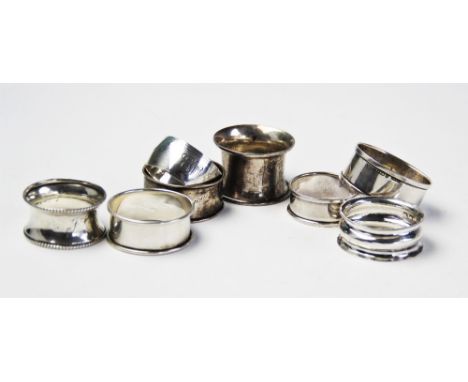 A selection if eight Edwardian and later silver napkin rings, to include and example by Williams Ltd, Birmingham 1905, of cir