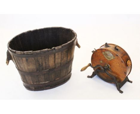 A coopered oak log barrel, 19th century, the oval barrel with handles formed from branch ends, bound with four iron bands, 51