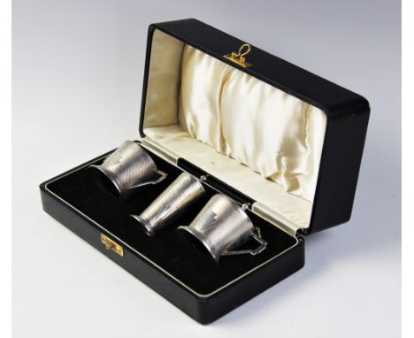 A silver Art Deco style cruet set by William Suckling Ltd, Birmingham 1940, comprising wet mustard, salt and pepperette each 