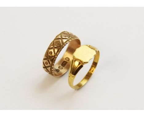 A 9ct gold signet ring, the central panel designed as a shield set to tapered engraved shoulders continuing to a plain polish