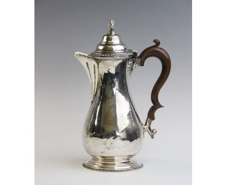 A George V silver hot water jug by George Nathan & Ridley Hayes, Chester 1914, of baluster form on stepped circular foot with