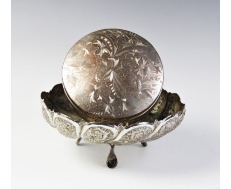 A Persian white metal tripod bowl, of circular scalloped form on three feet, with engraved and embossed decoration depicting 