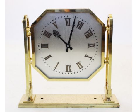 A mid 20th century lacquered brass Art Deco double sided electric ceiling clock, the octagonal 35cm silvered dials applied wi