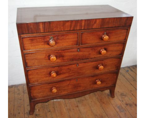 An early 19th century straight front mahogany chest of drawers, the rectangular top inlaid with ebonised stringing, above a f