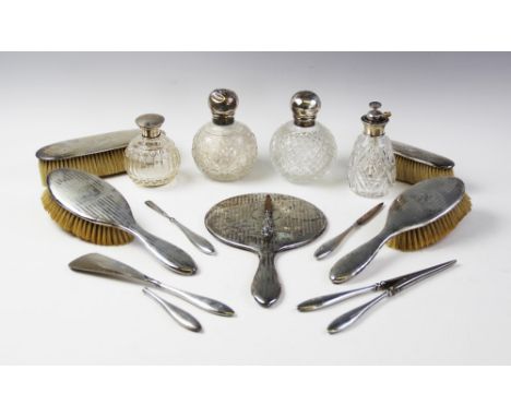 A silver mounted dressing table set by Birks, comprising eleven pieces including a hand-held mirror, two hairbrushes, two clo