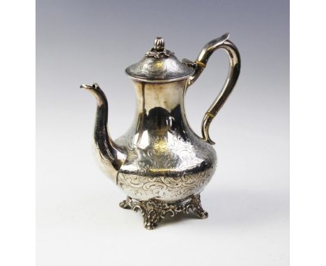 A Victorian silver coffee pot by John Wellby, London 1843, of baluster form on four scrolling feet, hinged lid with acorn fin