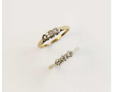 A diamond three stone ring, comprising a central brilliant cut diamond with a single cut diamond to each side, all set in whi