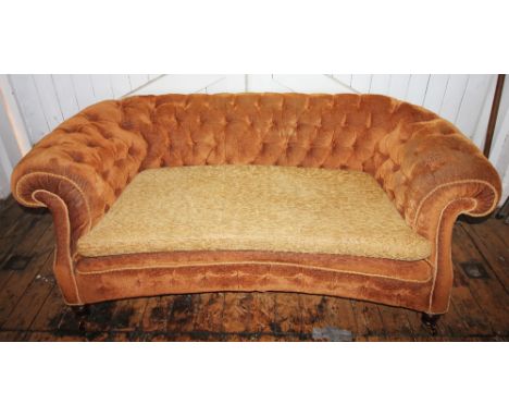 A Victorian Chesterfield type settee, later re-covered with golden brown fabric and rope edging, the deep set padded back and