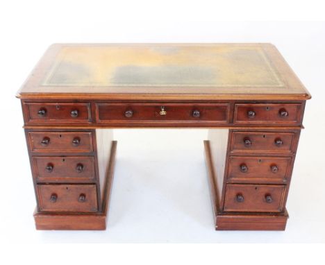 A Victorian mahogany twin pedestal desk, the rectangular moulded top inset with a gilt tooled green leather writing surface, 