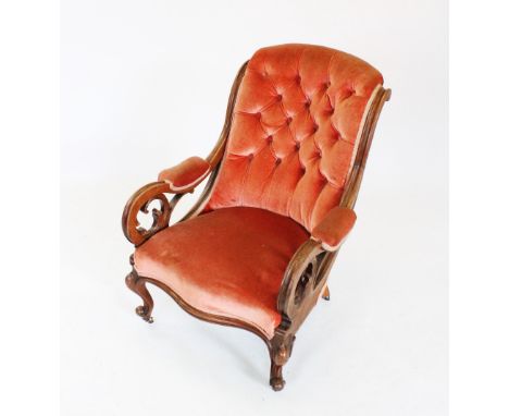 A mid 19th century mahogany framed open armchair, the padded button back flanked by channelled down swept arms extending to c