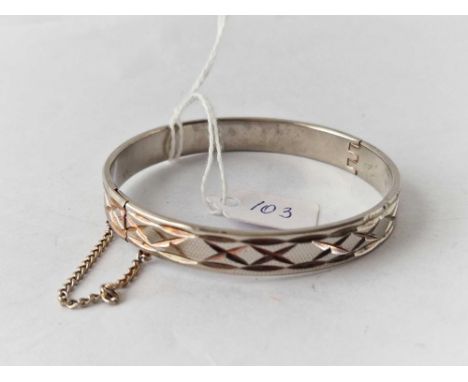 A fancy gold plated hinged bangle