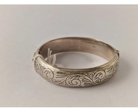 Silver hallmarked bangle with chased scroll decoration