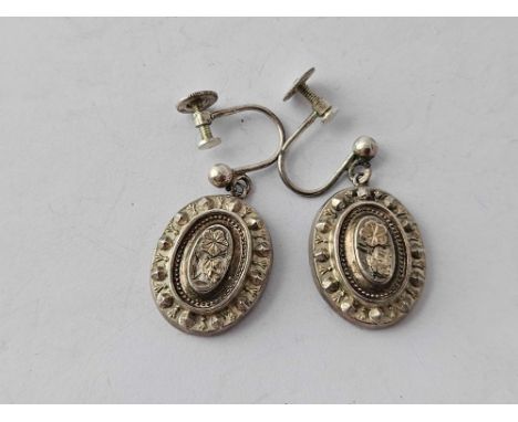 A pair of embossed silver earrings