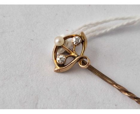 A pearl and diamond stick pin in oval art nouveau mount 15ct gold