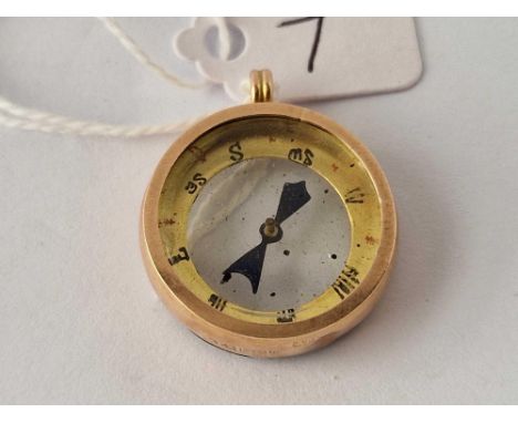 A circular gold compass pendant 6.1 gms